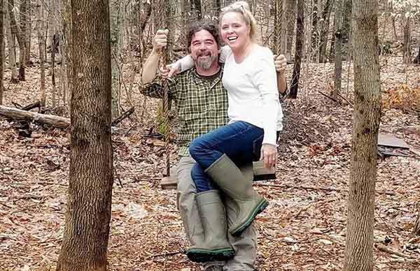 Image of Ryan Eldridge and Ashley Morrill were swinging together in the woods